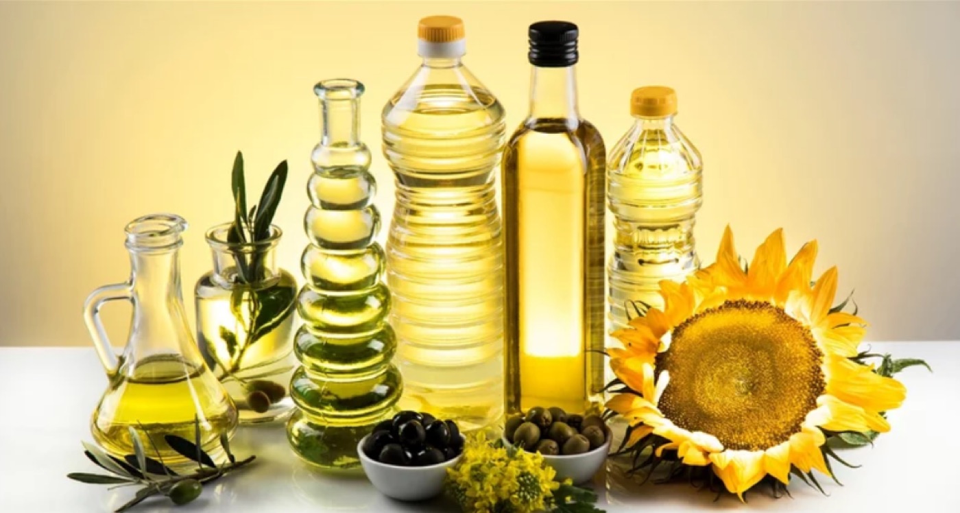 Assorted vegetable and seed cooking oils in glass bottles