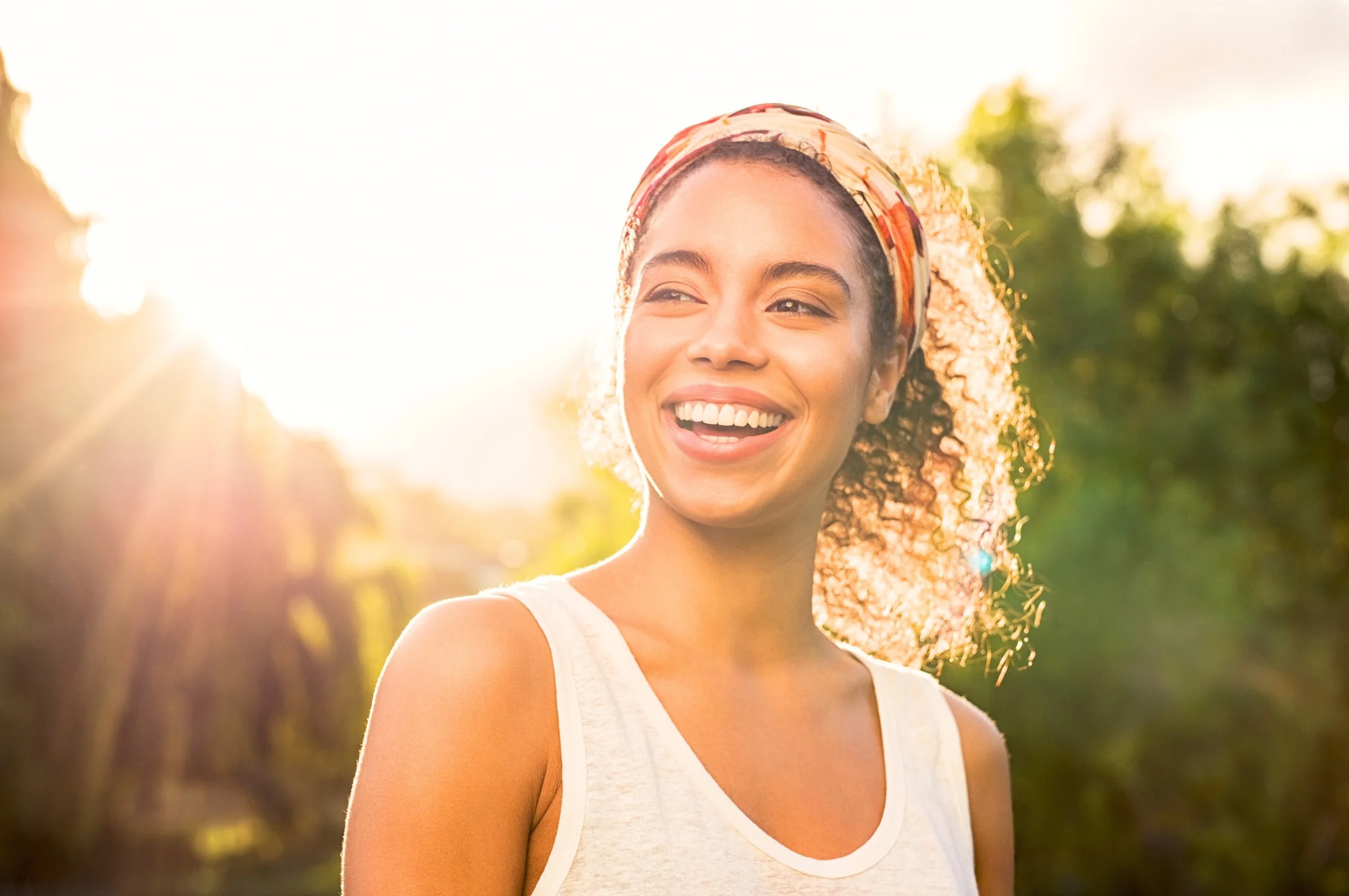 Woman smiling in sunlight outdoors